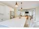 Open-concept kitchen with an island that overlooks a living room with a fireplace and coffered ceiling at 1062 Willow Ridge Ln, Fort Mill, SC 29707