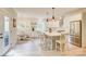 Eat-in kitchen with a center island, pendant lighting, white cabinets, and stainless appliances at 1062 Willow Ridge Ln, Fort Mill, SC 29707