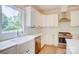 Well-lit kitchen showcases stainless steel appliances, subway tile backsplash, and a farmhouse sink under a window at 1062 Willow Ridge Ln, Fort Mill, SC 29707