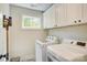 Bright laundry room featuring side-by-side washer and dryer and plenty of storage space at 1062 Willow Ridge Ln, Fort Mill, SC 29707
