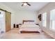 Spacious main bedroom features a barn door, two windows, and an accent wall with wall decor at 1062 Willow Ridge Ln, Fort Mill, SC 29707