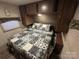 Comfortable main bedroom featuring a full size bed, overhead storage, and a cozy atmosphere at 107 Pine St, New London, NC 28127