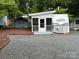 Cozy camper with screened porch, shed, and gravel lot offering a charming and convenient outdoor living space at 107 Pine St, New London, NC 28127