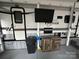 The exterior of this RV features an outdoor cabinet, a TV, and a trash can at 107 Pine St, New London, NC 28127