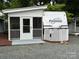 Charming camper with screened porch and white lattice skirting providing a cozy and private outdoor living space at 107 Pine St, New London, NC 28127