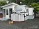 Exterior view of the Pioneer modular home on lot 204, with white siding, screened porch, and gravel driveway at 107 Pine St, New London, NC 28127