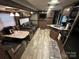 The recreational vehicle features a cozy living room with dark leather seating, a kitchen, and a dining area at 107 Pine St, New London, NC 28127