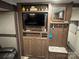 Entertainment center with flat screen TV, storage cabinets, and counter space, offering style and functionality at 107 Pine St, New London, NC 28127