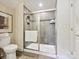 Modern bathroom featuring a tiled walk-in shower with glass doors and built-in shelves at 1226 Restoration Dr, Waxhaw, NC 28173