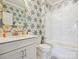 Stylish bathroom featuring patterned wallpaper, a glass shower, and a classic white vanity and toilet at 1226 Restoration Dr, Waxhaw, NC 28173