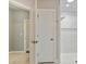 Bathroom doorway leads to a shower area, which features white tile and decorative wall accents at 1226 Restoration Dr, Waxhaw, NC 28173