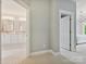 Hallway view of a bathroom with double sinks and a bedroom with a chandelier at 1226 Restoration Dr, Waxhaw, NC 28173