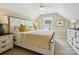 Bedroom featuring a large bed with a yellow patterned comforter, and white nightstands on either side at 1226 Restoration Dr, Waxhaw, NC 28173