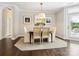 Dining room with seating for four around a wood table and a door leading to the outside at 1226 Restoration Dr, Waxhaw, NC 28173