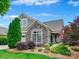Charming home with stone accents, manicured landscaping, and a well-maintained lawn under a bright blue sky at 1226 Restoration Dr, Waxhaw, NC 28173