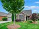 Charming home featuring a stone facade, well-manicured lawn, and mature trees in a tranquil setting at 1226 Restoration Dr, Waxhaw, NC 28173
