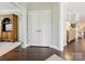 Hallway with hardwood floors leading to other areas of the home, showcasing neutral wall colors at 1226 Restoration Dr, Waxhaw, NC 28173