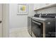 Well-lit laundry room featuring modern, front-loading washer and dryer set and neutral wall art at 1226 Restoration Dr, Waxhaw, NC 28173