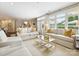Spacious living area with natural light, elegant sofas, and a seamless connection to the dining area at 1226 Restoration Dr, Waxhaw, NC 28173