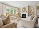 Elegant living room with fireplace, natural light, and stylish decor, creating a cozy atmosphere at 1226 Restoration Dr, Waxhaw, NC 28173