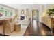 Bright living room with a fireplace, dark hardwood floors, and an open entryway to the front door at 1226 Restoration Dr, Waxhaw, NC 28173