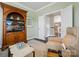 Inviting living room featuring built-in shelving, a comfortable chair, and soft lighting at 1226 Restoration Dr, Waxhaw, NC 28173