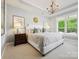 Bedroom with a chandelier, a decorative sunburst mirror, and large windows at 1226 Restoration Dr, Waxhaw, NC 28173