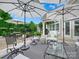 Large outdoor patio with dining and seating areas, umbrellas, and manicured landscaping at 1226 Restoration Dr, Waxhaw, NC 28173