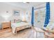 Bedroom with hardwood floors, a bright window, and comfortable furnishings at 12910 Meetinghouse Dr, Cornelius, NC 28031