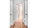 Hallway with an open door to a bright bathroom featuring natural light at 12910 Meetinghouse Dr, Cornelius, NC 28031