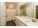 Bright bathroom with double sinks, white cabinets, quartz counters, and tub with shower at 153 Ole Eastpointe Dr, York, SC 29745