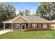 Charming brick home featuring a well-maintained lawn, covered front porch, and inviting curb appeal at 153 Ole Eastpointe Dr, York, SC 29745