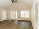 Bright living room features high vaulted ceilings, fan, wood-look flooring and white trim throughout at 153 Ole Eastpointe Dr, York, SC 29745