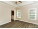 Inviting primary bedroom featuring tray ceiling, fan, natural light, and access to the en suite bathroom at 153 Ole Eastpointe Dr, York, SC 29745
