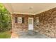 Covered patio featuring brick siding, white trim, and a concrete floor at 153 Ole Eastpointe Dr, York, SC 29745