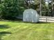 Backyard featuring a storage shed and a wooden fence, surrounded by mature trees at 1616 Lazenby St # 17, Newton, NC 28658
