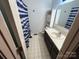 Bathroom with a single sink vanity, toilet, cabinet, and shower with patterned curtain at 1616 Lazenby St # 17, Newton, NC 28658