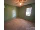 Bedroom featuring light carpet, green walls, a ceiling fan, and window with natural light at 1616 Lazenby St # 17, Newton, NC 28658