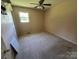 A modest bedroom with carpet flooring, light pink walls, and a ceiling fan at 1616 Lazenby St # 17, Newton, NC 28658