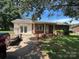 Single-story brick home with a well-maintained lawn and mature trees offering shade at 1616 Lazenby St # 17, Newton, NC 28658