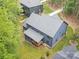 Aerial view of the home with a large gray roof and a back porch nestled among the trees at 18238 Youngblood N Rd, Charlotte, NC 28278
