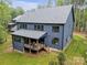 Stylish home exterior featuring a covered porch and a well-maintained backyard at 18238 Youngblood N Rd, Charlotte, NC 28278