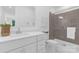 Modern bathroom with gray tiled shower and white cabinets at 18238 Youngblood N Rd, Charlotte, NC 28278