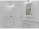 Bright bathroom with double sink vanity, white cabinets and framed mirrors at 18238 Youngblood N Rd, Charlotte, NC 28278