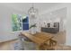 Dining area featuring a wood table, modern light fixture, and a view of the open concept kitchen at 18238 Youngblood N Rd, Charlotte, NC 28278