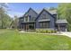 Beautiful two-story home with stone accents, a well-manicured lawn, and stylish architecture at 18238 Youngblood N Rd, Charlotte, NC 28278