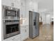 Kitchen showcases stainless steel appliances including microwave, oven, and refrigerator with white cabinetry at 18238 Youngblood N Rd, Charlotte, NC 28278