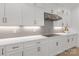 Bright white kitchen featuring subway tile backsplash, sleek countertops, and modern stainless steel vent hood at 18238 Youngblood N Rd, Charlotte, NC 28278