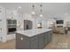 Elegant kitchen featuring white cabinetry, marble countertops, a center island, and stainless steel appliances at 18238 Youngblood N Rd, Charlotte, NC 28278