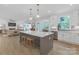 Open-concept kitchen featuring a large center island, modern pendant lighting, and stainless steel appliances at 18238 Youngblood N Rd, Charlotte, NC 28278